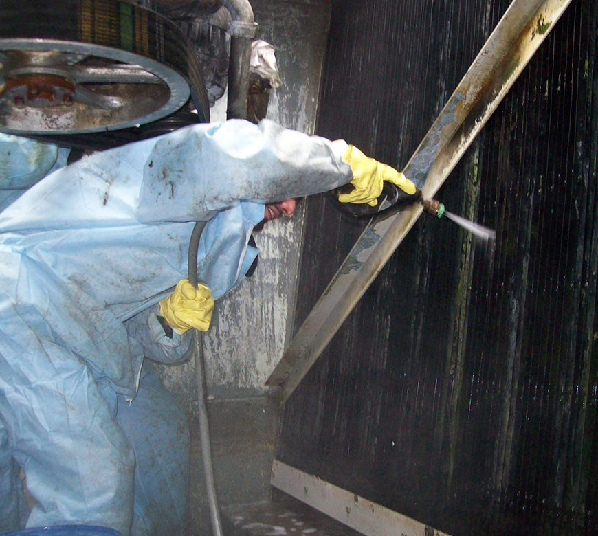 Cooling tower cleaning services in New York City, NY, with man inside of a unit