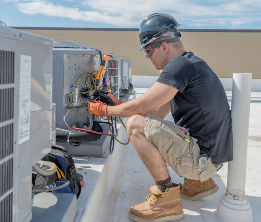 Man on the roof doing a Commercial Air Handler Cleaning in Manhattan