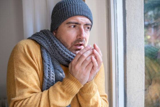 a man struggling to warm up that could benefit from Small Portable Air Conditioner Rental in Queens, NY